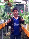 179 Our favorite Peruvian kid, carrying orchids in the greenhouse.JPG